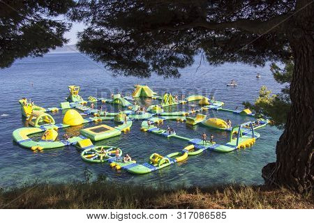 Bol, Croatia - August 06, 2019: Water Fun Park On A Zlatni Rat Beach In Bol On The Island Of Brac