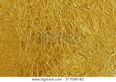 Gold Foil Leaf Shiny Texture, Abstract Yellow Wrapping Paper For Background And Design Art Work.