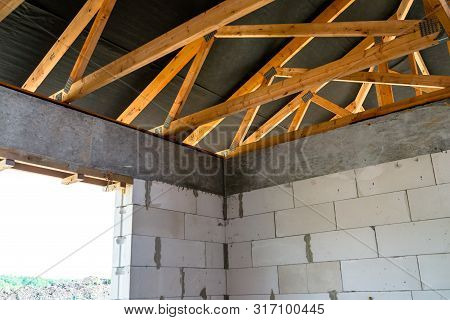 Roof Trusses Covered With A Membrane On A Detached House Under Construction, Visible Roof Elements, 