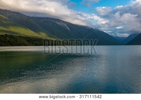 A View Down The Length Of The Incredibly Beautiful Rotoiti Lake Surrounded By Mountains Which Is Par