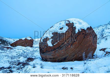 Large Red Boulders At Red Rock Coulee, Alberta, Canada In The Evening On A Cold Winter Day
