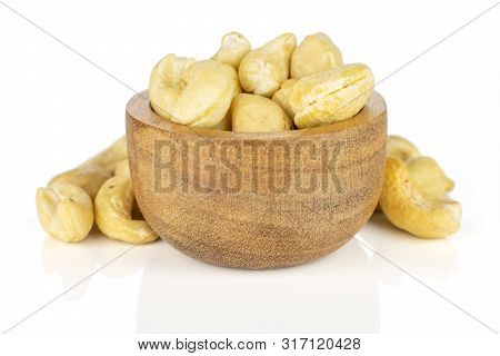Lot Of Whole Unsalted Beige Cashew In Tiny Wooden Bowl Isolated On White Background