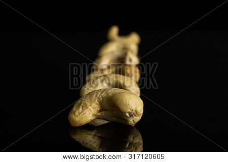 Lot Of Whole Unsalted Beige Cashew Isolated On Black Glass