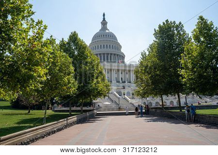 Washington, Dc - August 7, 2019: The Us Capitol Building, With Tourists Taking Photos And Relaxing I
