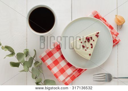 Piece Of Cheesecake On Gray Plate On Kitchen Spatula And Cup Of Coffee On Background