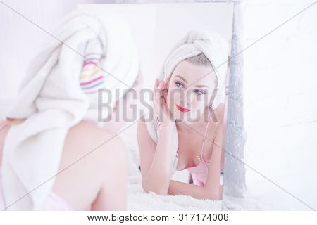 Attractive Young Woman Wrapped With Bath Towel After A Shower At The Bathroom.