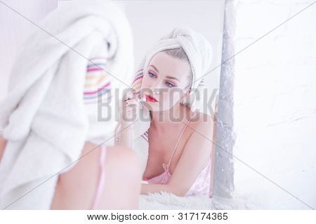 Attractive Young Woman Wrapped With Bath Towel After A Shower At The Bathroom.