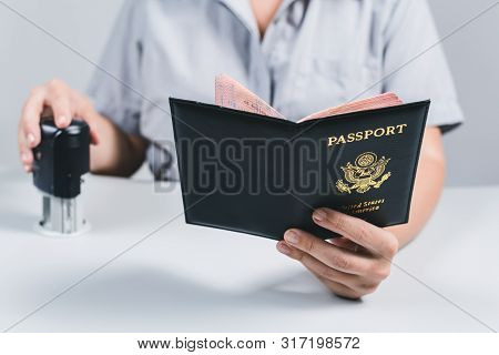 Immigration And Passport Control At The Airport. Woman Border Control Officer Puts A Stamp In The Us
