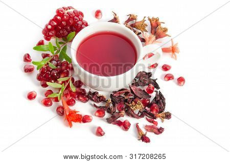 Parts Of A Pomegranate With Pomegranate Seeds And Leaves, Flowers, Dry Tea Of Carcade And Full Cup O