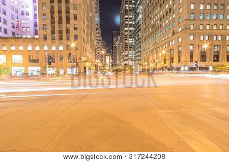 Wacker Dr Street With Tall Buildings And Street Light Trails In Chicago At Night