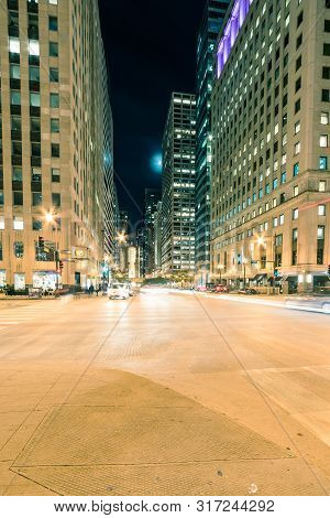 Wacker Dr Street With Tall Buildings And Street Light Trails In Chicago At Night