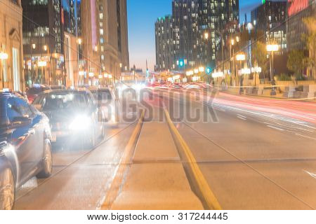 Blurry Background Wacker Dr Street With Tall Buildings And Street Light Trails In Chicago At Night