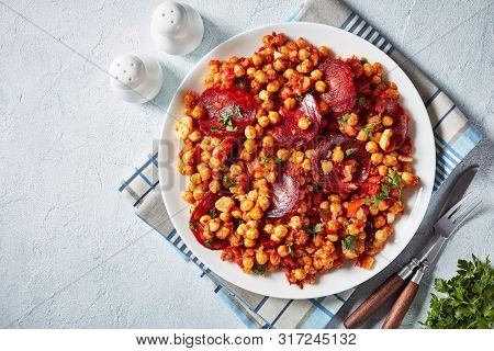 Garbanzos Fritos, Hot Chickpea Stew With Sliced Chorizo, Ham, Tomatoes And Spices On A White Plate O