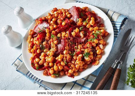 Garbanzos Fritos, Hot Chickpea Stew With Sliced Chorizo, Ham, Tomatoes And Spices On A White Plate O
