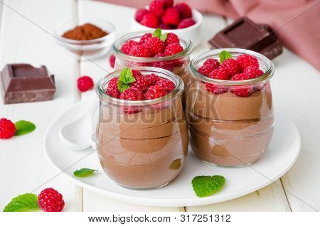 Chocolate Pudding (mousse) With Fresh Raspberries In Glass Jars