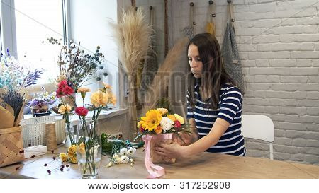 Female Florist In Flower Shop At Work.