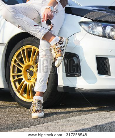 Kiev, Ukraine; January 20, 2014. Subaru Impreza Wrx Sti. Girl In Colored Sneakers And In White Trous
