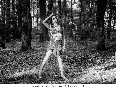 Desire. Wild Woman In Forest. Sexy Girl In Leather Clothes. Deep Forest. Cougar Female. Amazon Woman