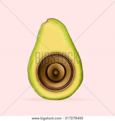 Juicy Sound Of Favourite Songs. Avocado With Speaker Inside It On Coral Background. Negative Space T