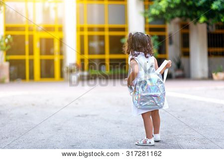 Back To School. Cute Child Girl With Holographic Backpack Running And Going To School With Fun.back,