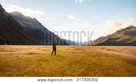 A Tourist Holding Camera Taking Photo At The View Point Of Ellington Valley While Travelling Along T