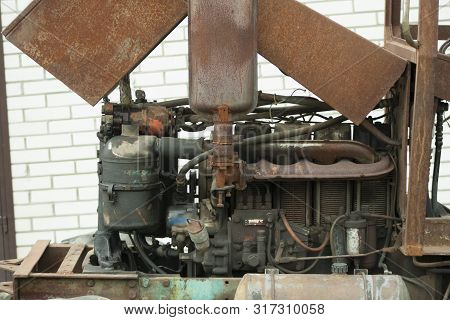 Engine On Old Rusty Tractor. Non-painted Metal