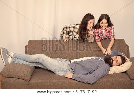 Family Prank. Little Girl With Mother Cut Fathers Beard. Happy Family At Home. Bearded Man Relax On 