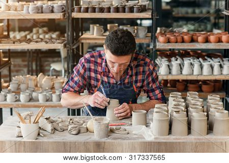 Caucasian Male Potter Making Ceramic Cap In The Pottery.