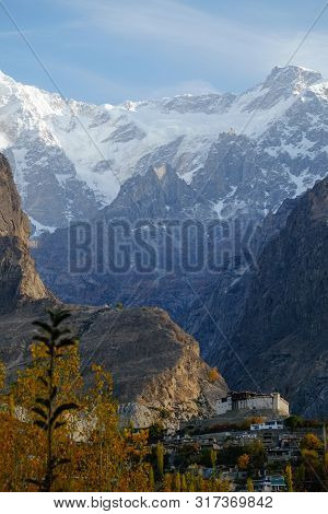 Nature Landscape Vertical View Of Baltit Fort And Snow Capped Karakoram Mountain Range In The Backgr