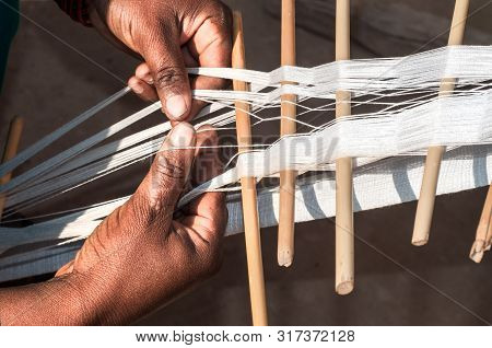 A Woman Is Working With The Threads