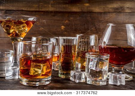 Assortment Various Hard And Strong Alcoholic Drinks In Different Glasses: Vodka, Cognac, Tequila, Br