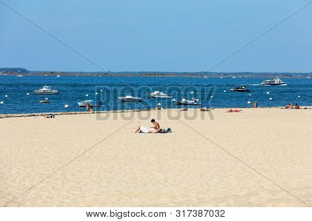 Arcachon, France - September 10, 2018: People Are Enjoying A Sunny Day On A Sandy Beach In Arcachon,