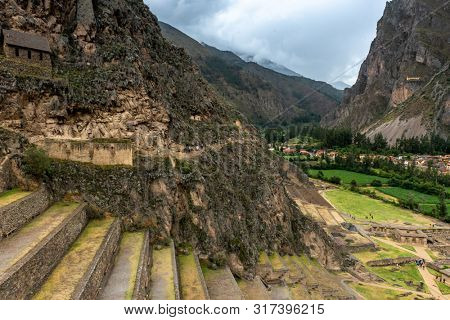 Ancient greened Terraces of Pumatallis at the Inca Fortress in amazing city of Ollantaytambo, Peru.