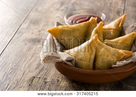 Samsa Or Samosas With Meat And Vegetables In Bowl On Wooden Table. Traditional Indian Food. Copyspac