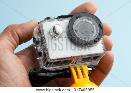 Action Camera In A Waterproof Box And A Buoy For Diving In Drops Of Water In Hand.