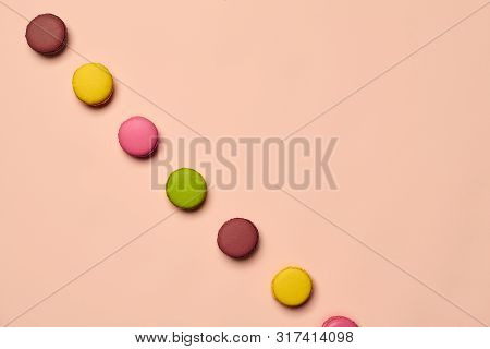 Colored Macaron Or Macaroon, Sweet Meringue-based Confection On Pink Background. Close-up, Copy Spac