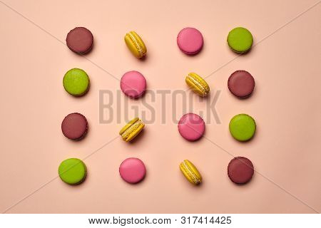 Colored Macaron Or Macaroon, Sweet Meringue-based Confection On Pink Background. Close-up, Copy Spac