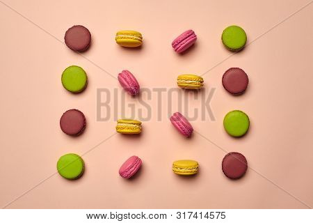 Colored Macaron Or Macaroon, Sweet Meringue-based Confection On Pink Background. Close-up, Copy Spac