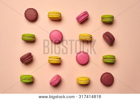 Colored Macaron Or Macaroon, Sweet Meringue-based Confection On Pink Background. Close-up, Copy Spac
