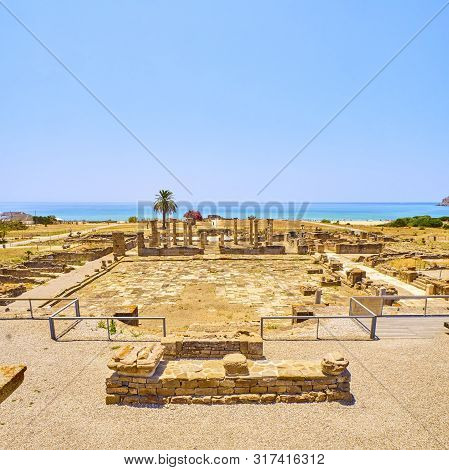 Remains Of The Forum Square With The Basilica In The Background. Baelo Claudia Archaeological Site. 