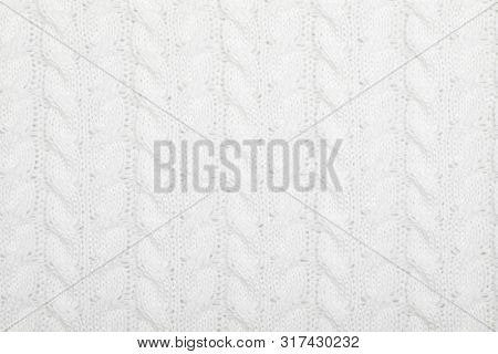 Real white knitted fabric with  cable pattern textured background