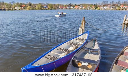 Canoes At The Stadtsee Lake In Molln, Germany