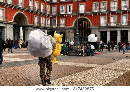 Madrid, Spain- March 7, 2019: Black Illegal Street Vendors Fleeing From The Police In La Plaza Mayor
