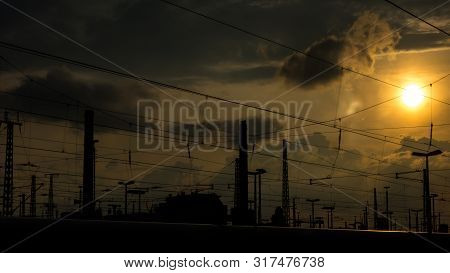 Catenary Cables Cross The Sun In The Background