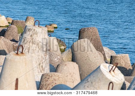 Breakwaters In Sea. Beautiful Sunset Seascape With Concrete Tetrapodes For Protect Coastal Structure