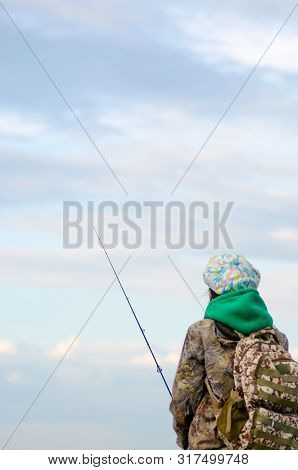 Yakut Girl Tourist With Backpack Fisherman Fishing Spinning Reel In The Cap And Boots Of The Vilyui 