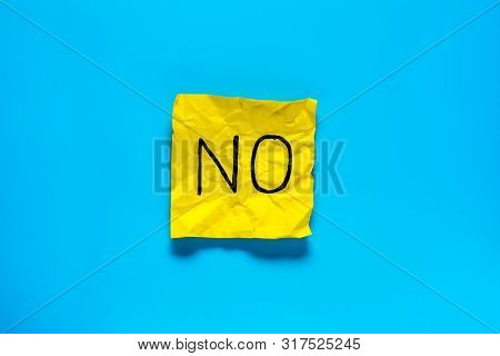 Close Up Black Handwritten Inscription No Word On One Yellow Square Sticker On Blue Background With 