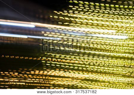 Abstract Of Multicolored Lights Stripes Moving Fast In Dark Background. Orange Violet And Bluel Back