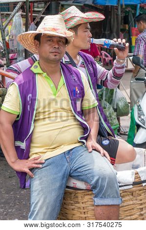 Bangkok, Thailand - June 12th 2016: Porters Waiting For Business On Khlong Toei Market. This Is The 