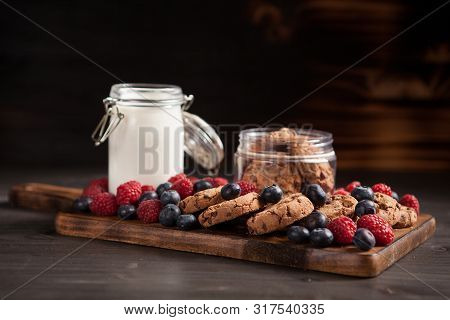 Delicious Brown Cookies On Wooden Plate With Fresh Bluebarries